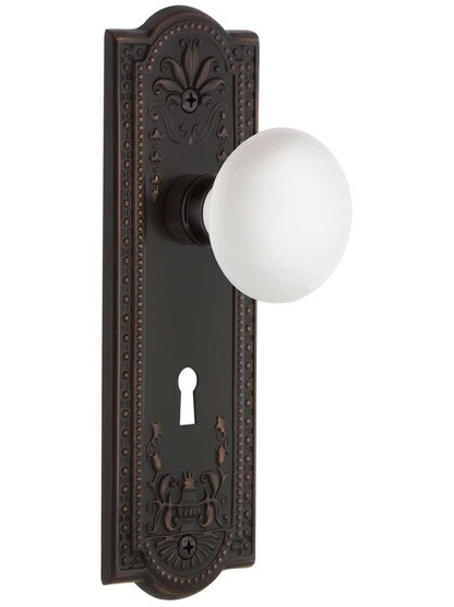 Meadows Design Mortise Lock Set With White Porcelain Door Knobs in Timeless Bronze.